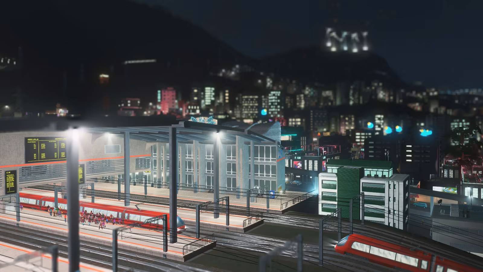 Endstation eines großen Bahnhofs in Cities: Skylines bei Nacht.